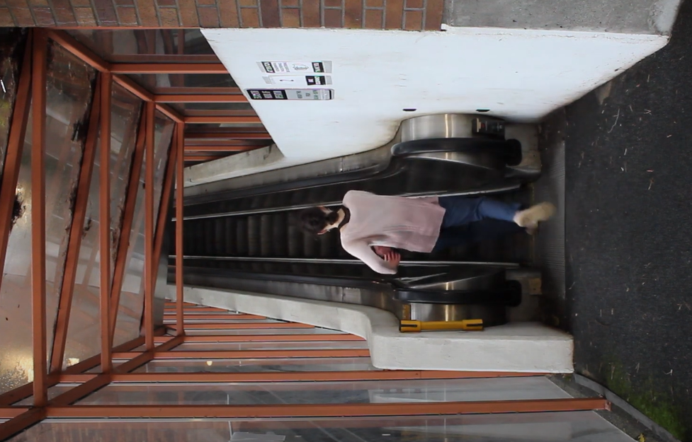 one dancer on an escalator